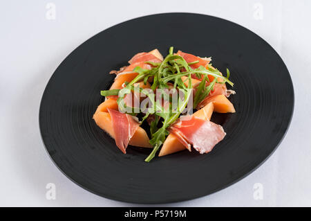 traditional Italian appetizer parma ham with melon - prosciutto melone Stock Photo