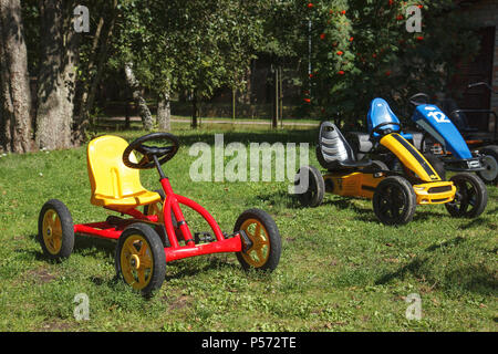 children pedal car awaiting riders at children park Stock Photo