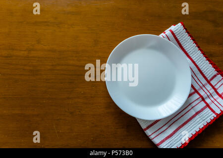 Empty plate on wooden table. View from the top. Stock Photo