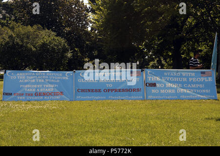 Washington, DC, USA. 25th June, 2018. Several signs, some with the US flag and/or the flag of East Turkestan on them as well as phrases such as, ''America give refuge to the displaced Uyghurs across the world'' and ''President Trump! Take a stand'''' and ''Apply the global magnitsky act to Chinese oppressors'' seen placed on the lawn to the East of the Capitol Building in Washington, DC. Credit: Evan Golub/ZUMA Wire/Alamy Live News Stock Photo