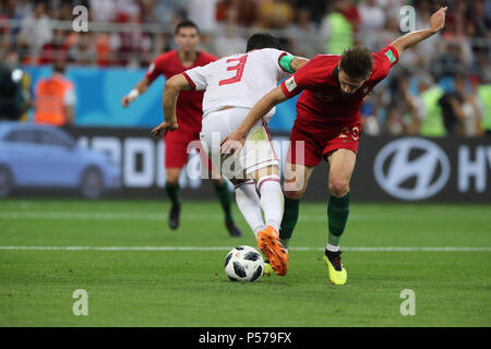 Iran's Ehsan Hajsafi (L) battles for the ball with Portugal's Andre Silva during the FIFA World Cup 2018 Group B soccer match between Iran and Portugal, at the Mordovia Arena in Saransk, Russia, 25 June 2018. Photo: Saeid Zareian/dpa Stock Photo