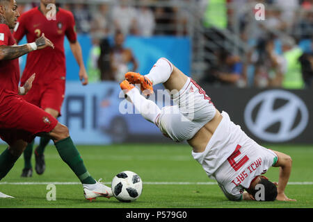 Iran's Ehsan Hajsafi (R) falls to the ground during the FIFA World Cup 2018 Group B soccer match between Iran and Portugal, at the Mordovia Arena in Saransk, Russia, 25 June 2018. Photo: Saeid Zareian/dpa Stock Photo
