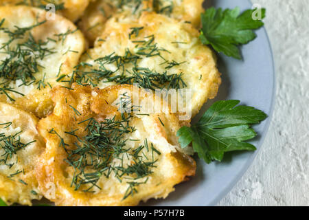 Roasted (fried) slices zucchini in egg batter with garlic Stock Photo