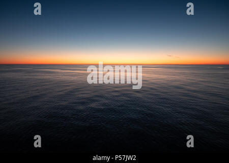 Empty landscape with calm sea and scenic sunset in Gulf of Finland Stock Photo