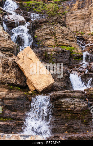 Waterfall along the side of Going to the Sun Road in Glacier National Park in Montana. Stock Photo