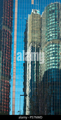 Skyscrapers being reflected in the glass wall another skyscraper on a bright sunny day in Sydney, New South Wales, Australia Stock Photo