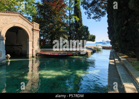 Isola del Garda, Italy – May 28, 2017: Small harbor at Isola del Garda, the biggest island on Lake Garda that has been open to visitors since 2001 Stock Photo