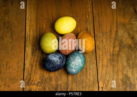 Beautiful natural colored happy easter eggs on wooden table. Raw organic food with color from only natural ingredients. Good, fresh and healthy diet Stock Photo