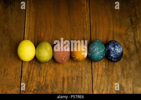 Beautiful natural colored happy easter eggs on wooden table. Raw organic food with color from only natural ingredients. Good, fresh and healthy diet Stock Photo