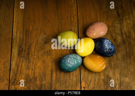 Beautiful natural colored happy easter eggs on wooden table. Raw organic food with color from only natural ingredients. Good, fresh and healthy diet Stock Photo