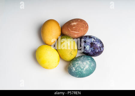 Beautiful natural colored happy easter eggs on white background. Raw organic food with color from only natural ingredients. Good, fresh and healthy Stock Photo