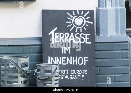 Slate in front of a restaurant with a caption in German 'Terrace in the courtyard' Stock Photo