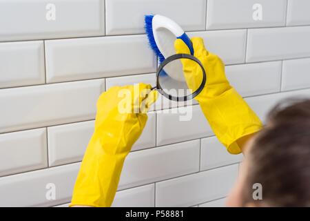 Professional cleaning service. Cleaning brush under the magnifier. Stock Photo
