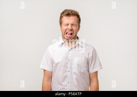 Crying european man in white shirt. He lost his work or wife. His life is ruined. Stock Photo