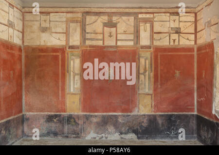 Mural painting in the fourth style with red panels separated by architectural elements in the Laundry of Stephanus (Fullonica di Stephanus) in the archaeological site of Pompeii (Pompei) near Naples, Campania, Italy. Stock Photo