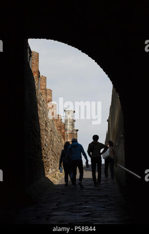 Visitors going through the Marine Gate (Porta Marina) in the archaeological site of Pompeii (Pompei) near Naples, Campania, Italy. Stock Photo