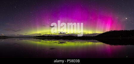 Bright and colourful aurora display with reflections Stock Photo