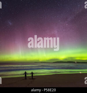 Couple dancing on the beach under the Aurora Stock Photo
