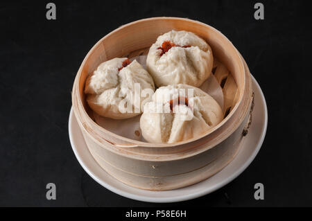 Steamed bun stuffed with barbecued roast pork; cha siu sou Stock Photo