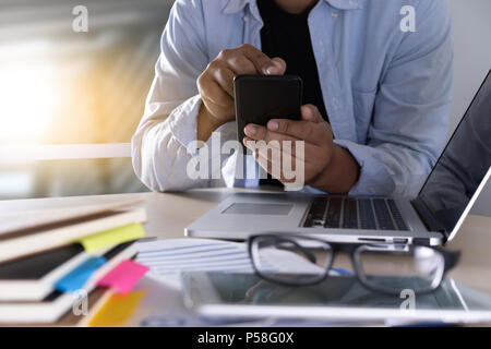 businessman using phone smart phone and notebook computer Stock Photo
