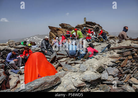 SIERRA NEVADA, SPAIN - JUNE 23, 2018: Unidentified group of mountaineers rest on top of Mulhacen, the highest peak in the Iberian Peninsula Stock Photo