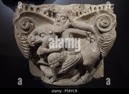 Samson slaying the lion depicted in the Romanesque capital from the Church of the Monastery of Aguilar de Campoo on display in the National Archaeological Museum (Museo Arqueológico Nacional) in Madrid, Spain. Stock Photo