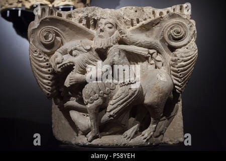Samson slaying the lion depicted in the Romanesque capital from the Church of the Monastery of Aguilar de Campoo on display in the National Archaeological Museum (Museo Arqueológico Nacional) in Madrid, Spain. Stock Photo