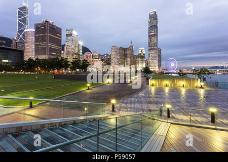 Stunning sunset view of the Central business district in Hong Kong island from the waterfront promenade along the Victoria harbor in Hong Kong, China Stock Photo