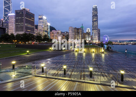 Stunning sunset view of the Central business district in Hong Kong island from the waterfront promenade along the Victoria harbor in Hong Kong, China Stock Photo