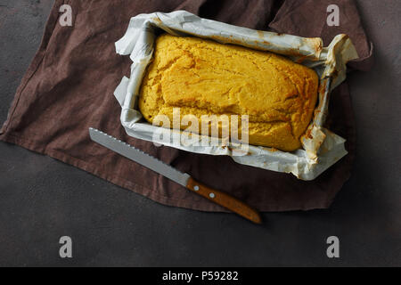 Close up fresh loaf cornbread on dark background top view Stock Photo