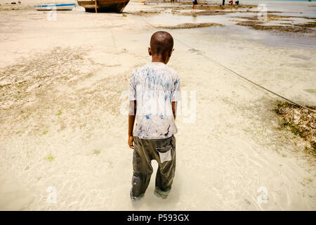 African child in search of seafood in the ocean Stock Photo