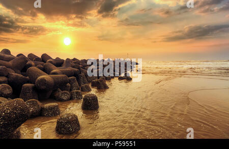 Sunrise at rocky sea beach at Digha Mohona West Bengal India. Stock Photo