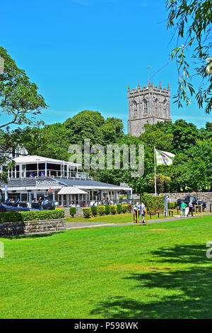 The Boathouse is a modern family-friendly café & restaurant at Christchurch Quay, Dorset. Christchurch Priory, a Norman church is in the background Stock Photo
