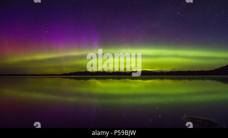 Colourful Aurora display with reflections Stock Photo
