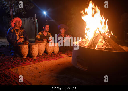 MEKNES - TAFILALET, MOROCCO - CIRCA APRIL 2017: Moroccan men singing in a berber camp at night in the Sahara Desert. Stock Photo