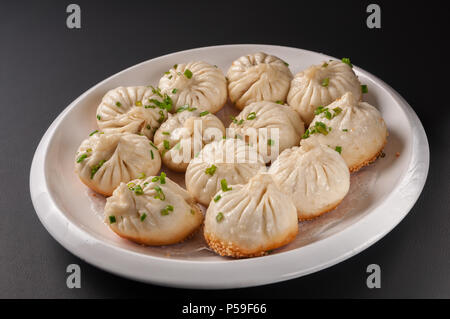 Shanghai Pan-Fried Baozi Stuffed with Pork Stock Photo