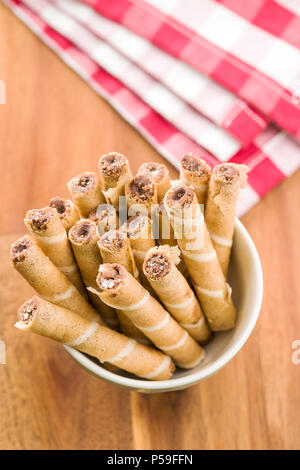 Sweet chocolate waffle rolls in bowl. Stock Photo