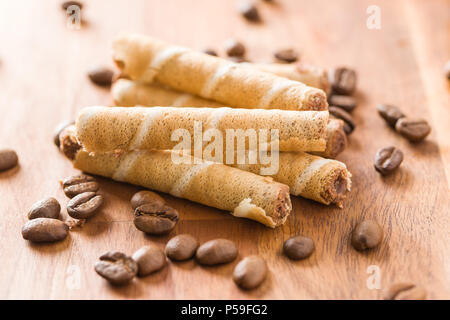 Sweet chocolate waffle rolls and coffee beans. Stock Photo