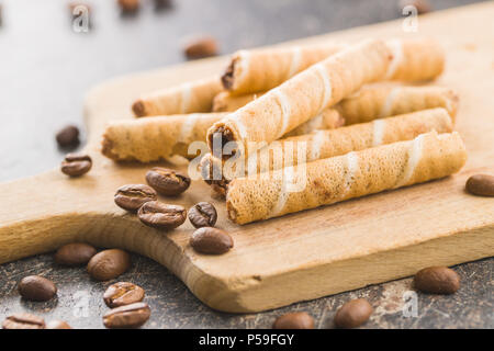 Sweet chocolate waffle rolls and coffee beans. Stock Photo