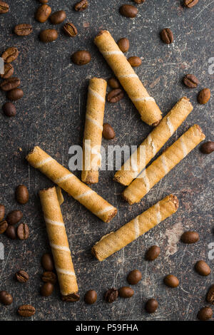 Sweet chocolate waffle rolls and coffee beans. Stock Photo