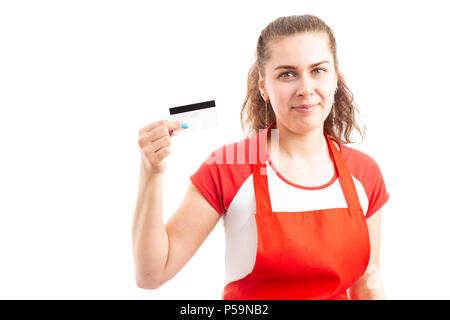 Young woman supermarket or hypermarket worker holding credit card as secure payment for shopping concept isolated on white background Stock Photo