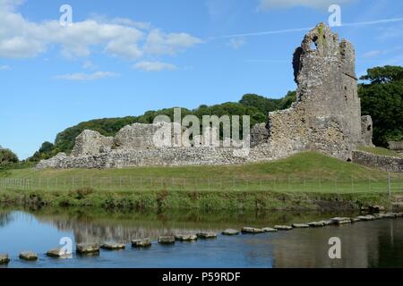 Ogmore Castle a Grade 1 listed ruin and stepping stones on the Ewenny River Ogmore by Sea Wales Cymru UK Stock Photo