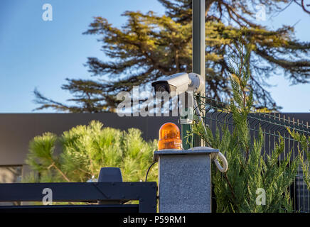 Security equipment - lamp and camera. Surveillance security camera equipment on pole and copy space Stock Photo