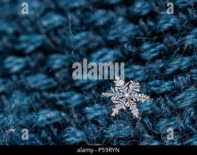 Extreme macro of snowflake crystals on hairy glove Stock Photo