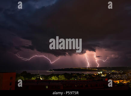 beautiful powerful lightning strikes over the sea and city, Varna. Bulgaria Stock Photo