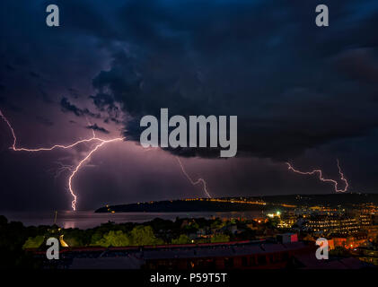 beautiful powerful lightning strikes over the sea and city, Varna. Bulgaria Stock Photo