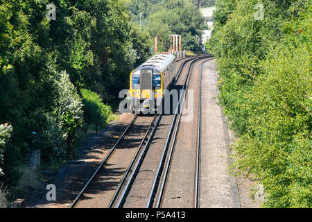 Holton Heath Station, Dorset, UK.  26th June 2018. UK Weather.   A London bound train at Holton Heath with delays on South Western Railways in Dorset after a small fire under a train between Surbiton and Weybridge blocked the West bound line.  This incident is on top of the speed restrictions on the railways due to the risk of the lines buckling due to the hot temperatures from the current heatwave.  Picture Credit: Graham Hunt/Alamy Live News Stock Photo