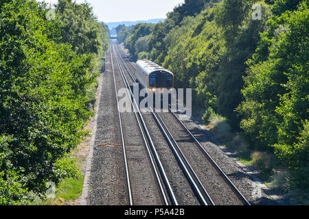Holton Heath Station, Dorset, UK.  26th June 2018. UK Weather.   A London bound train at Holton Heath with delays on South Western Railways in Dorset after a small fire under a train between Surbiton and Weybridge blocked the West bound line.  This incident is on top of the speed restrictions on the railways due to the risk of the lines buckling due to the hot temperatures from the current heatwave.  Picture Credit: Graham Hunt/Alamy Live News Stock Photo