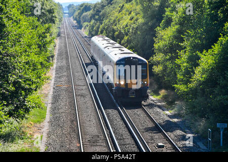 Holton Heath Station, Dorset, UK.  26th June 2018. UK Weather.   A London bound train at Holton Heath with delays on South Western Railways in Dorset after a small fire under a train between Surbiton and Weybridge blocked the West bound line.  This incident is on top of the speed restrictions on the railways due to the risk of the lines buckling due to the hot temperatures from the current heatwave.  Picture Credit: Graham Hunt/Alamy Live News Stock Photo