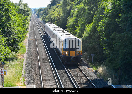 Holton Heath Station, Dorset, UK.  26th June 2018. UK Weather.   A London bound train at Holton Heath with delays on South Western Railways in Dorset after a small fire under a train between Surbiton and Weybridge blocked the West bound line.  This incident is on top of the speed restrictions on the railways due to the risk of the lines buckling due to the hot temperatures from the current heatwave.  Picture Credit: Graham Hunt/Alamy Live News Stock Photo